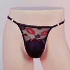 Black lace lingerie with red accents on a mannequin against a light background