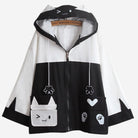 Black and white jacket with cartoon cat design on a white background