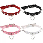 Four spiked chokers in red, black, pink, and white with heart-shaped charms on a white background.