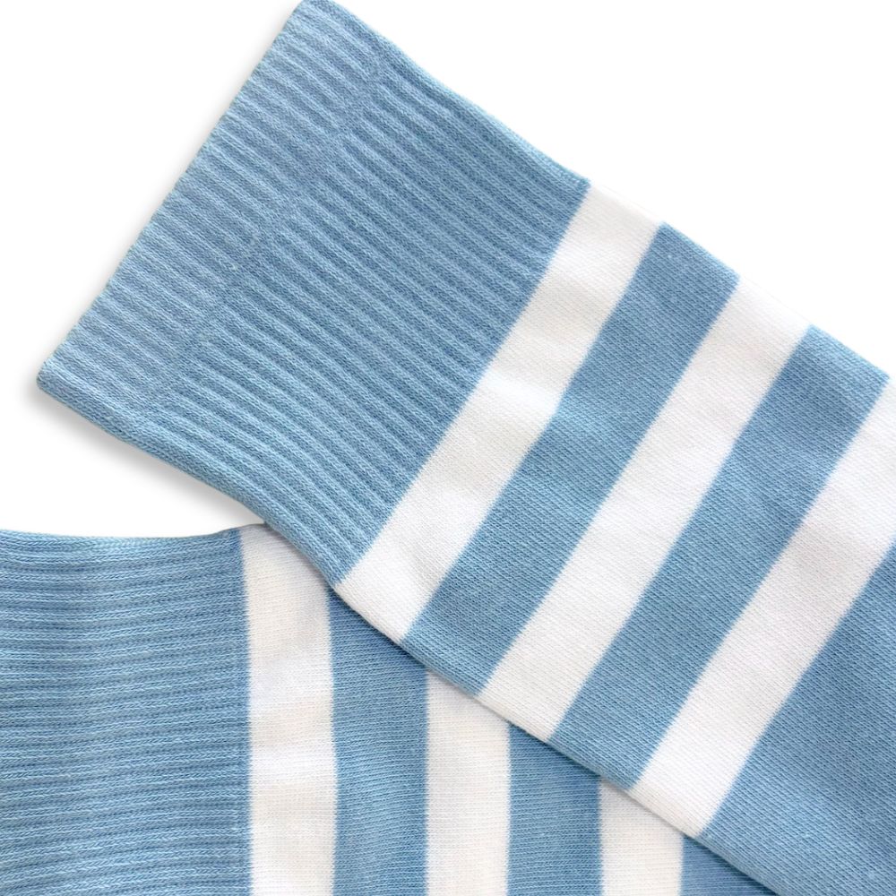 Blue and white striped socks on a light gray background