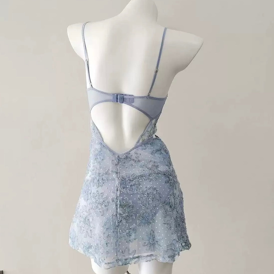Mannequin wearing a light blue lace nightgown against a plain background