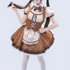 Femboy wearing a brown and beige maid outfit on a light gray background