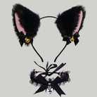 Black faux fur cat ears headband with pink inner lining, black bows, small gold bells, and a matching black ruffled collar with a large black bow and skull charm, shown on a light gray background.
