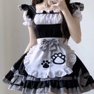 Person wearing a black and white maid outfit with paw print design on an apron.