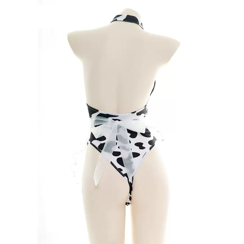 Black and white cow print hollow out bodysuit lingerie on a mannequin against a white background