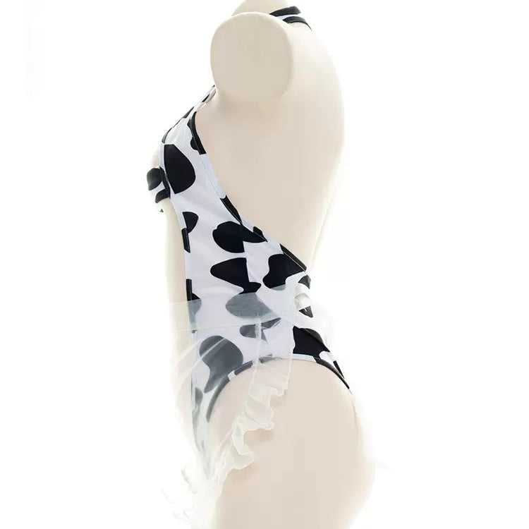 Black and white cow print hollow out bodysuit lingerie on a mannequin against a white background