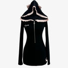 A black long-sleeve hooded dress with a front zipper, featuring a ruffled light pink hood trim with cat-ear details and small white paw-print graphics near the chest and hem.