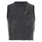 Black sleeveless distressed top with a star-shaped brooch on a white background