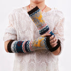 Person wearing elk fingerless knit arm warmers on a white background