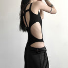 Person wearing a black sexy black hollow out sleeveless bodysuit