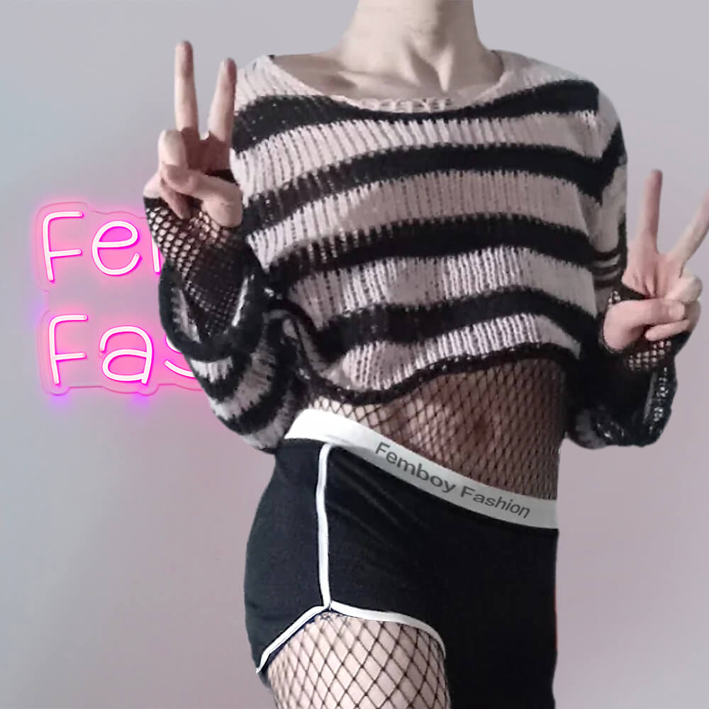 Femboy in pink and black striped distressed crop sweater with black short