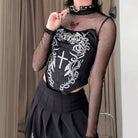 Person wearing a black tank top with white designs and fishnet sleeves.