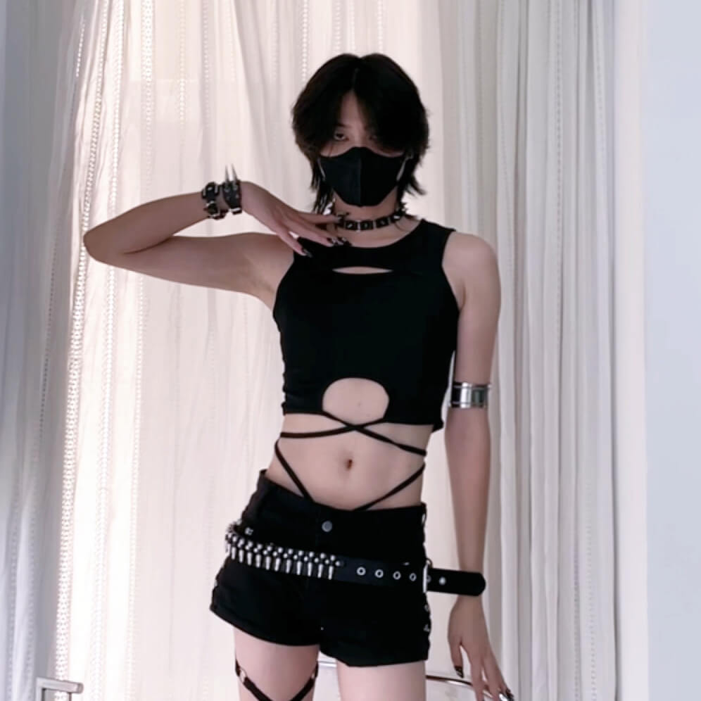 Black sleeveless top with cut-out design on a plain background