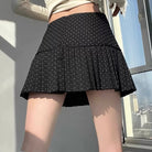 Femboy in black polka dot pleated skirt back