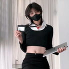 Femboy wearing a black mask and holding a laptop and ID card against a neutral background