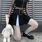 Femboy in black skirt and top with white fishnet pantyhose with butterfly