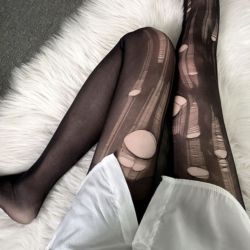 Femboy in black translucent ripped pantyhose