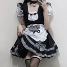 Person wearing a black and white cat femboy cosplay maid dress