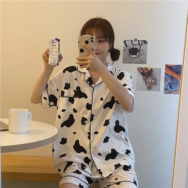 Femboy in cow print short sleeve top and shorts pajama set