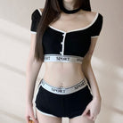 Person wearing a black and white sports-themed outfit with visible branding.