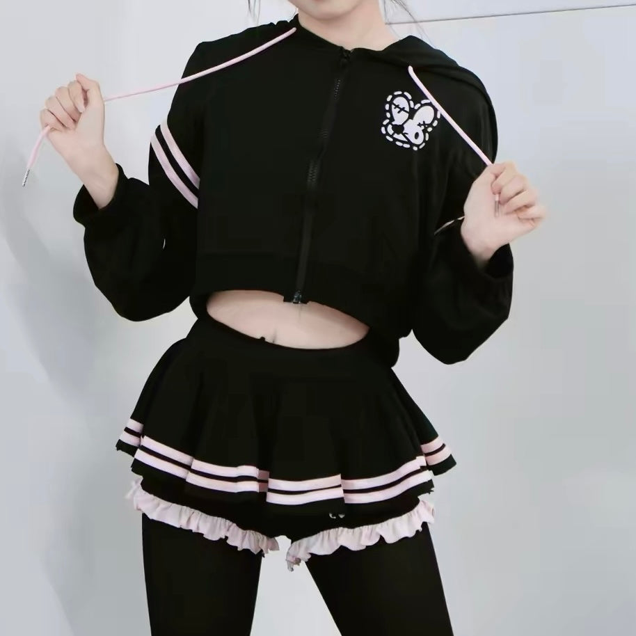 A femboy wearing a black  crop hoodie and mico skirt set
