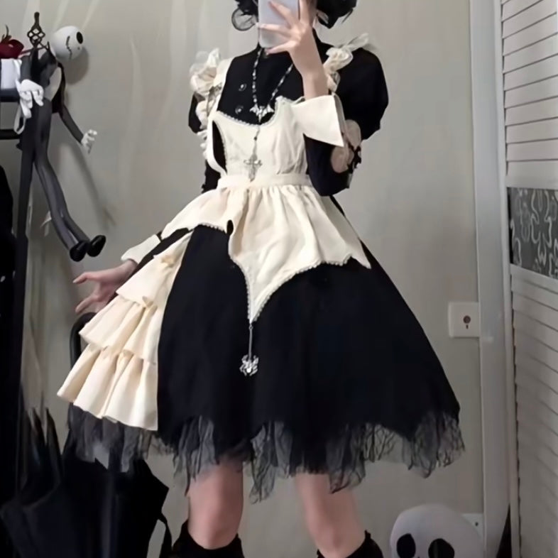 Person wearing a black and white dress with ruffled details in an indoor setting.