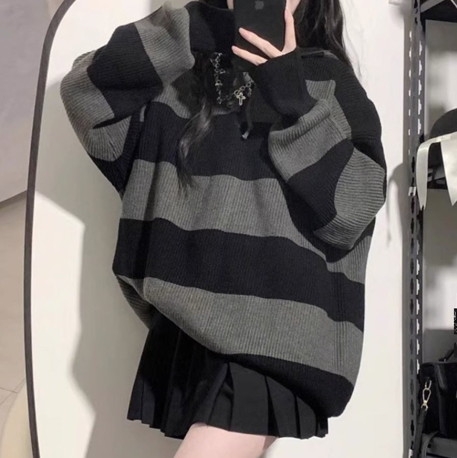 Femboyin a gray and black oversize sweater