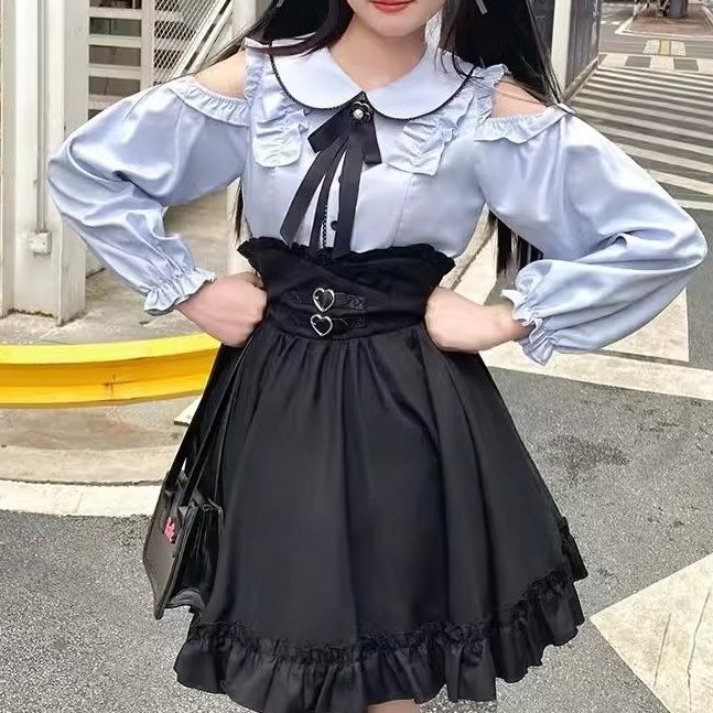 Person wearing a black and blue outfit with a black skirt and blue blouse.