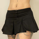 Femboy in low waisted black mini skirt