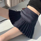 Femboy in navy polka dot pleated skirt