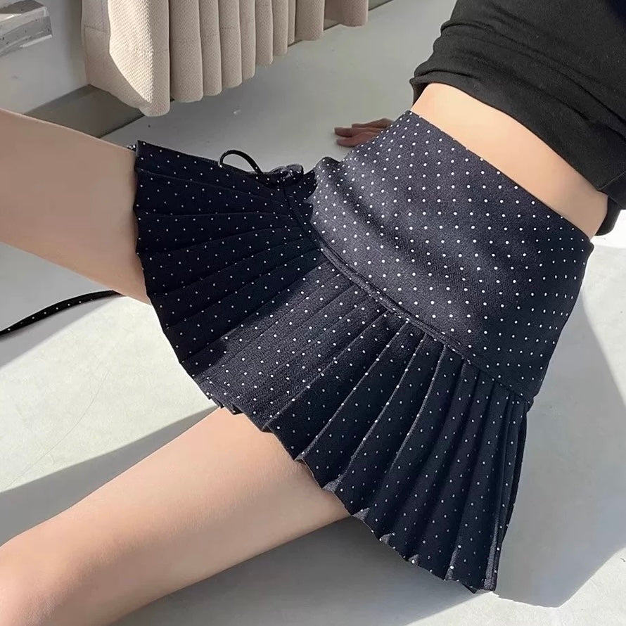 Femboy in navy polka dot pleated skirt