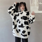 Femboy in oversize black and white cow print hoodie front