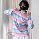 Person wearing a colorful striped sweater and white skirt indoors.