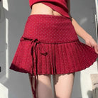 Femboy in red polka dot pleated skirt