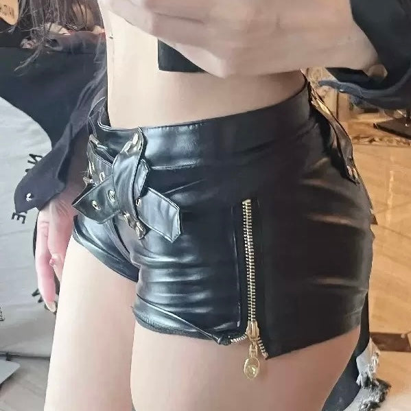 Black leather shorts with lace-up front and studded details on a plain background