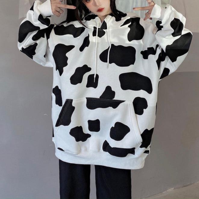 Femboy in white and black oversize cow print hoodie