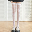 femboy in white poker print thigh high stockings