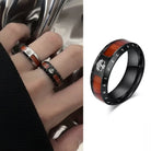 Black ring with wooden inlay worn on a finger, and a close-up of the ring on a white background.