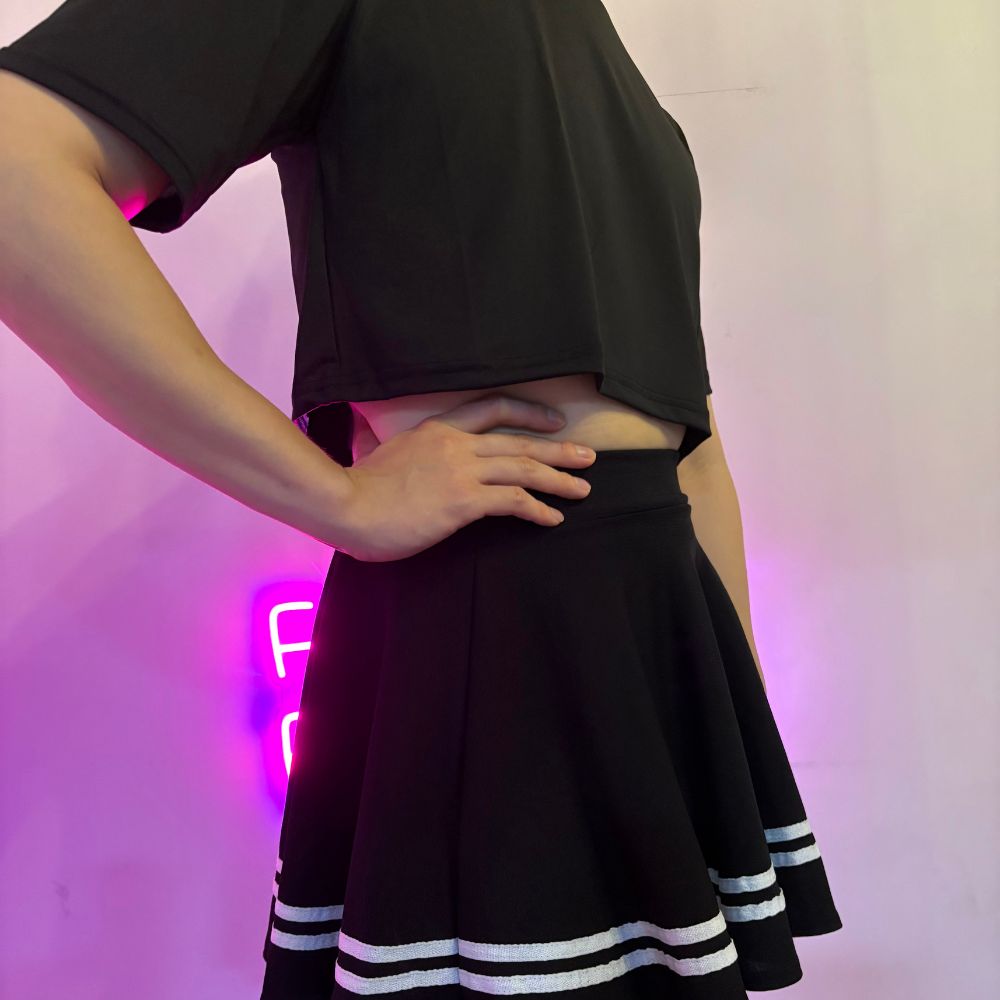 Femboy wear a classic black skirt and black crop top