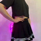 Femboy wear a classic black skirt and black crop top