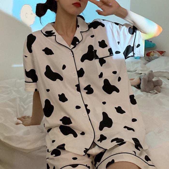 Femboy wear a cow print short sleeve top and shorts pajama set