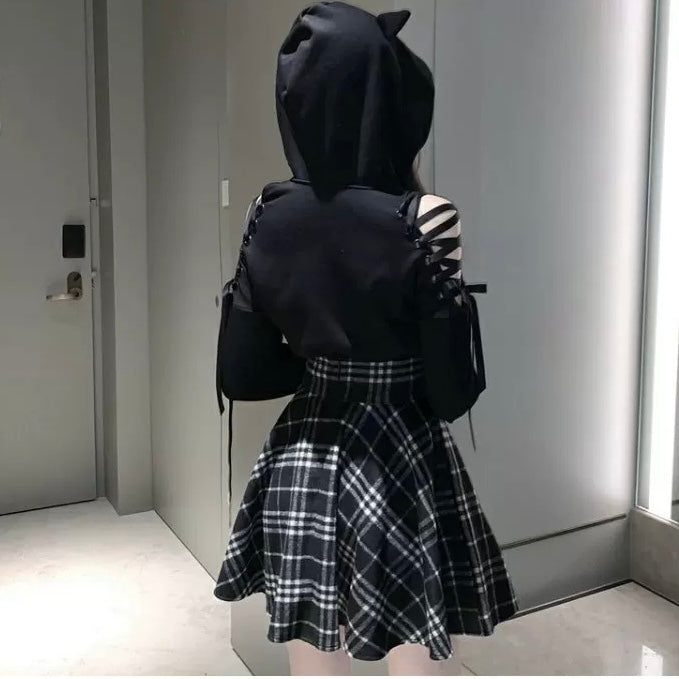 Femboy wear a high waisted black and white plaid skirt and black car ear hoodie back