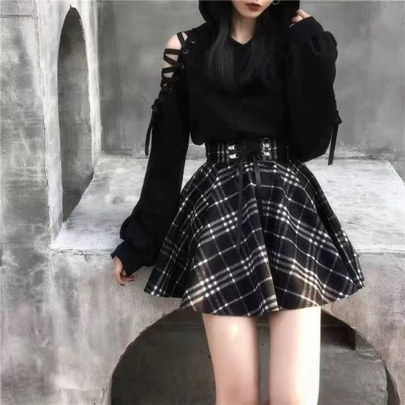 Femboy wear a high waisted black and white plaid skirt and black car ear hoodie