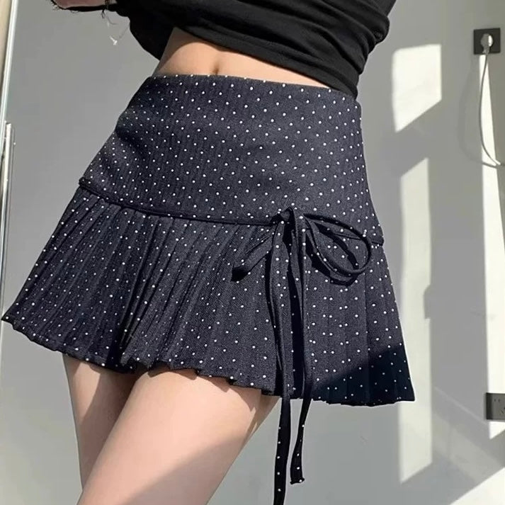 Femboy in navy polka dot pleated skirt
