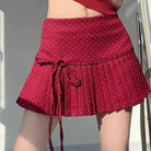 Femboy in red polka dot pleated skirt