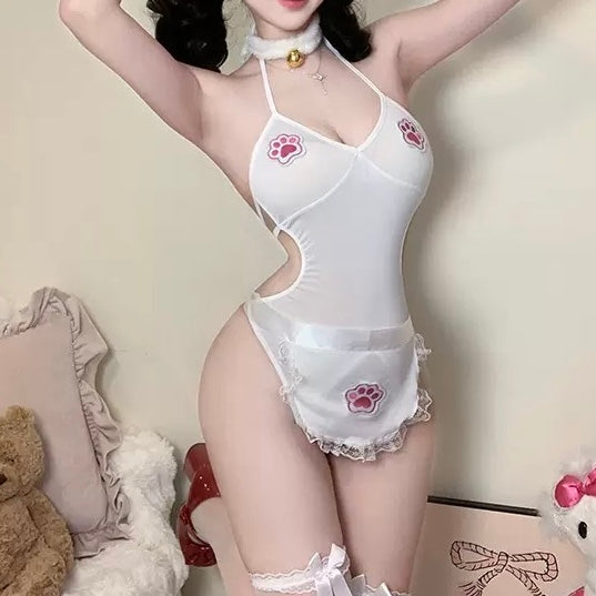 Person wearing a white lingerie set with pink paw prints in a room with stuffed animals.