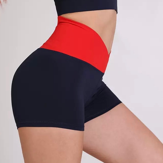 Black and red athletic femboy yoga shorts on a plain background