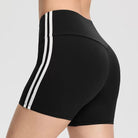 Black and white athletic femboy yoga shorts on a neutral background