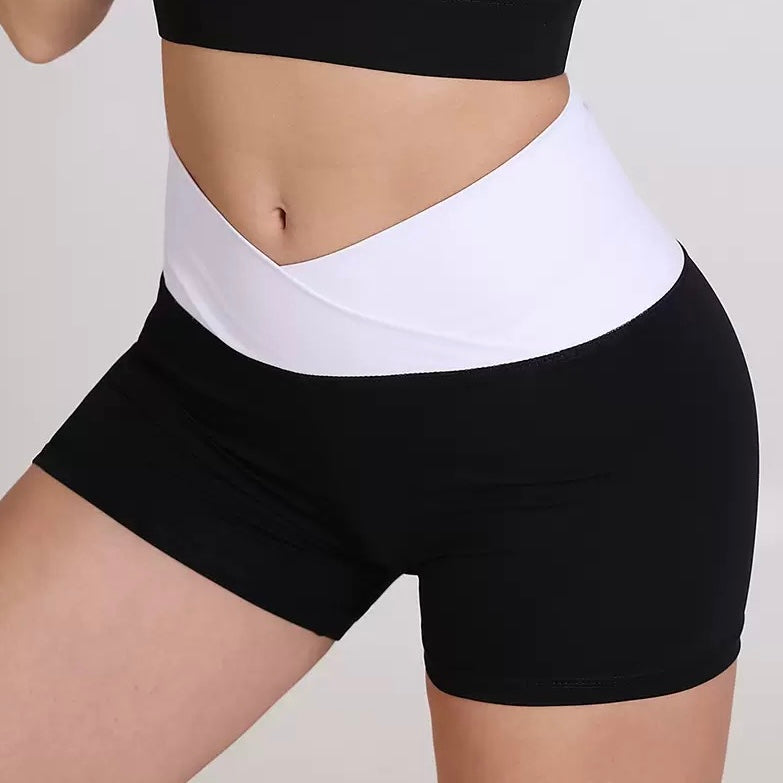 Black and white athletic femboy yoga shorts on a neutral background