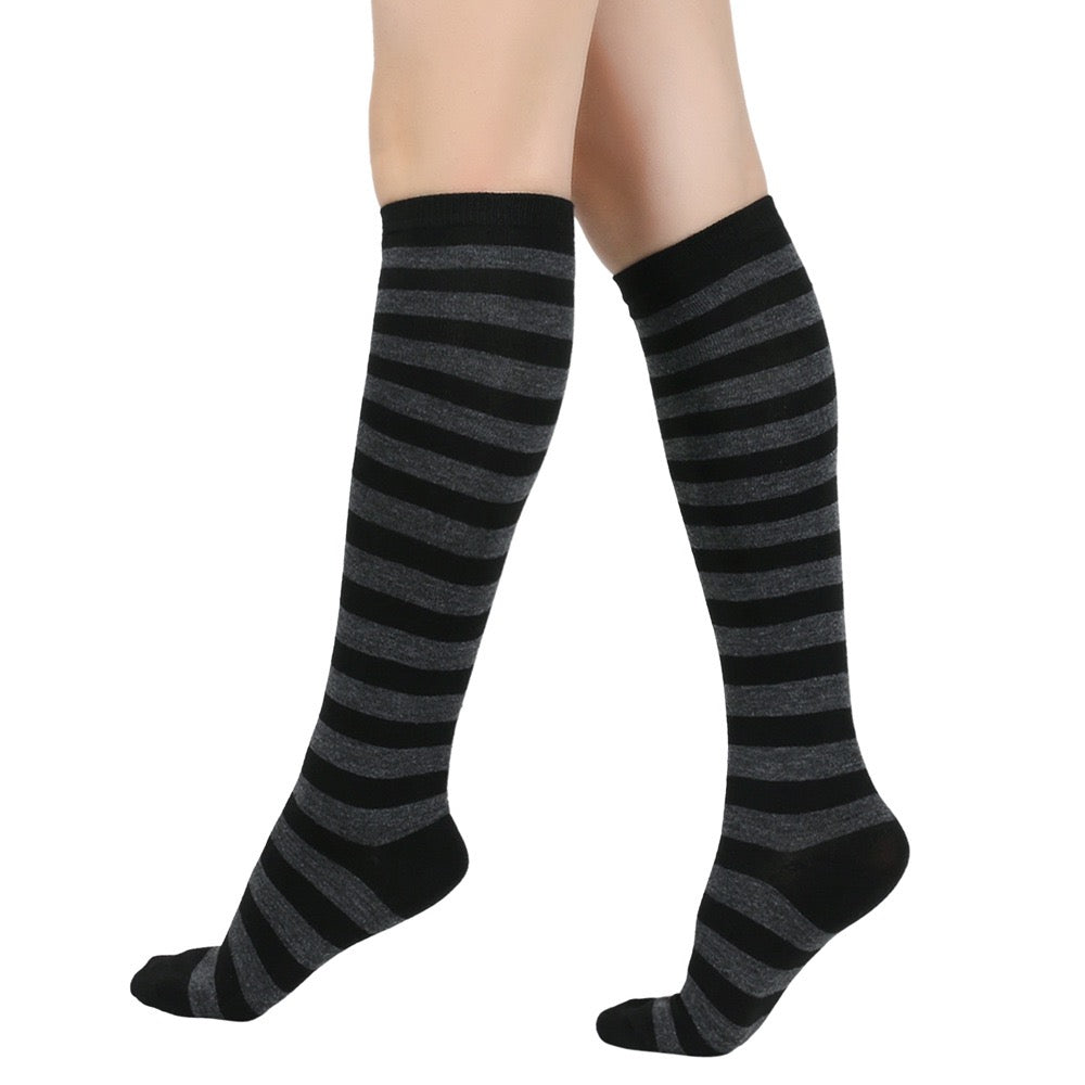 Black and gray femboy pin striped knee-high socks on a white background